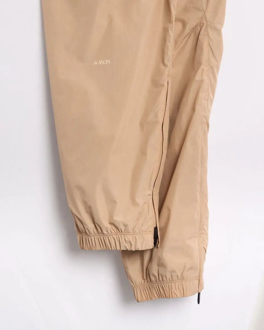 Conjunto Nike x NOCTA Woven Track Beige Areia/Café Claro